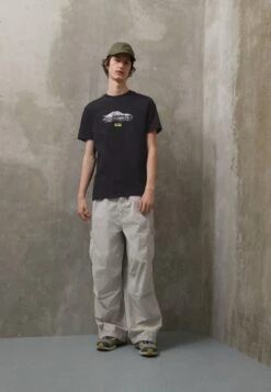 Pl GraphicT-Shirt Con StampaPuma Black Uomo T-shirt E Polo PU122O0OH-Q11 -Pier One Italia 2025 88a537f730014bd8aa7314c16708278b